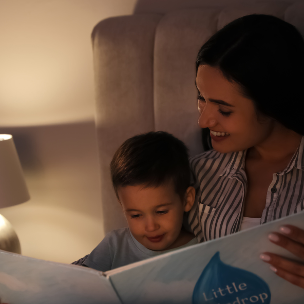 mom reading to son in bed